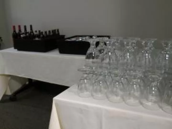 Glasses and bottles of wine arranged for a catered event