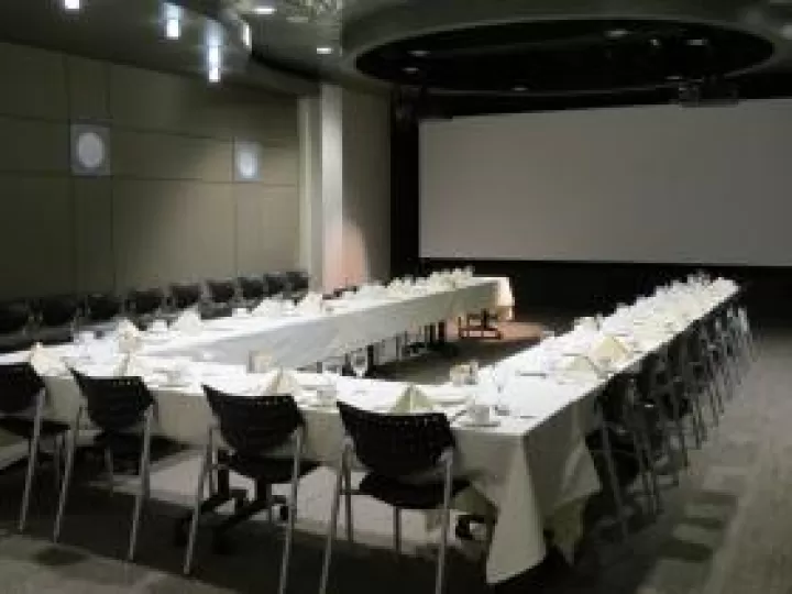 Tables with table clothes arranged for a dinner meeting