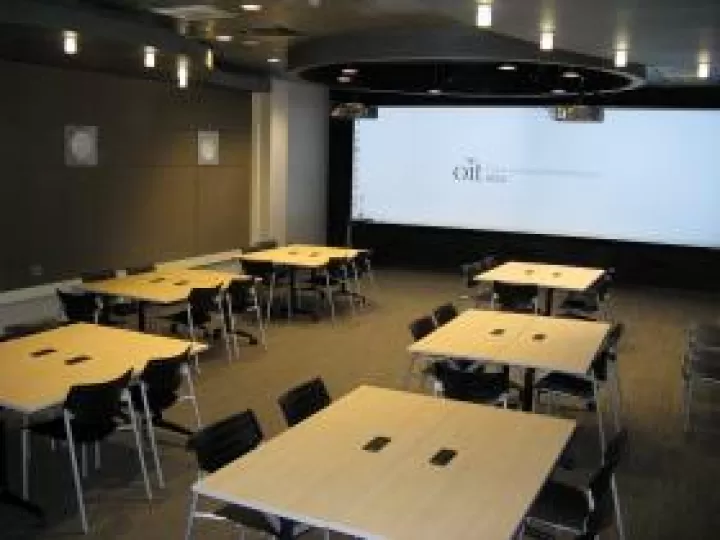 Tables arranged into groupings with four chairs seated around them