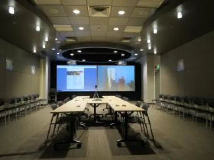 Tables pushed together to create a bigger, conference table with chairs around it