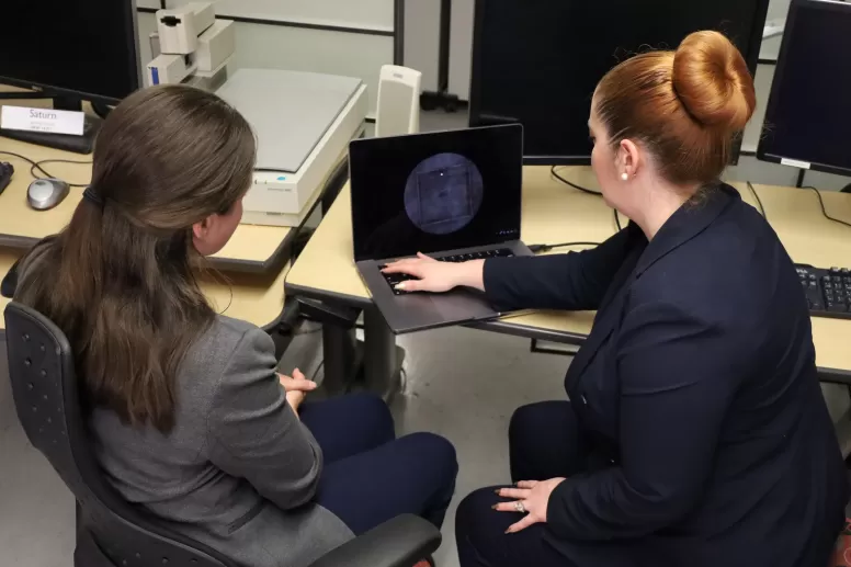 Two women looking at a laptop together
