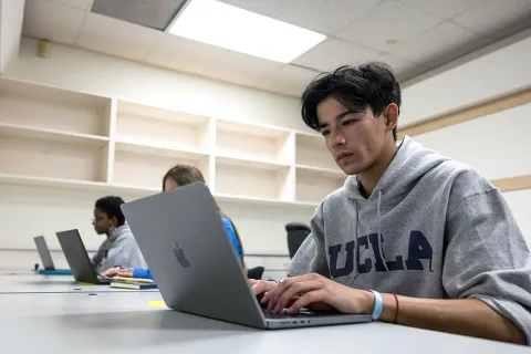 A student using a laptop for accessibility testing.